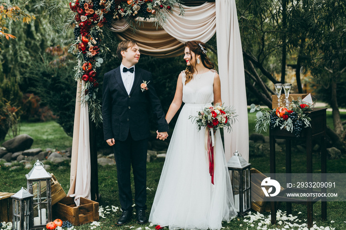 Elegant wedding couple in the autumn park