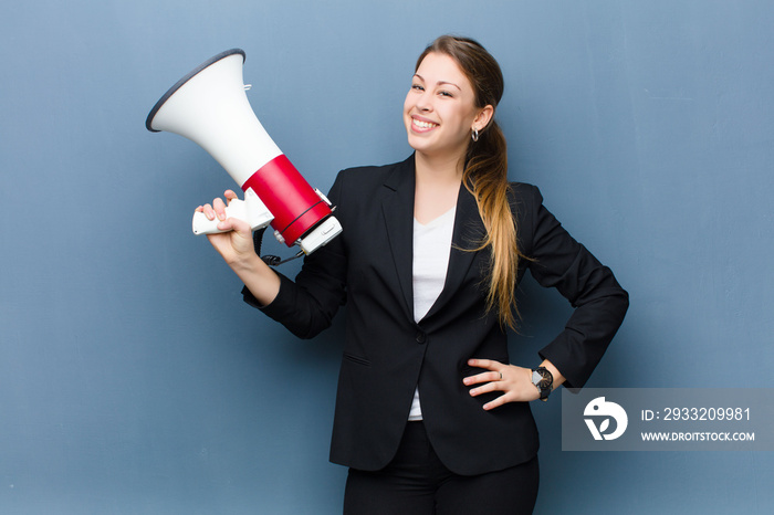 young blonde woman with a megaphone against grunge wall background