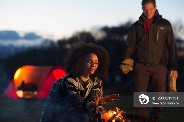 Couple toasting marshmallows at camp, Isle of Skye, Scotland