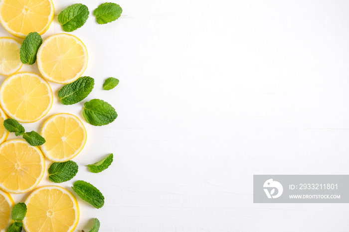 Fresh lemon slices on a white background. Background with lemon and mint. Beautiful photo with citru