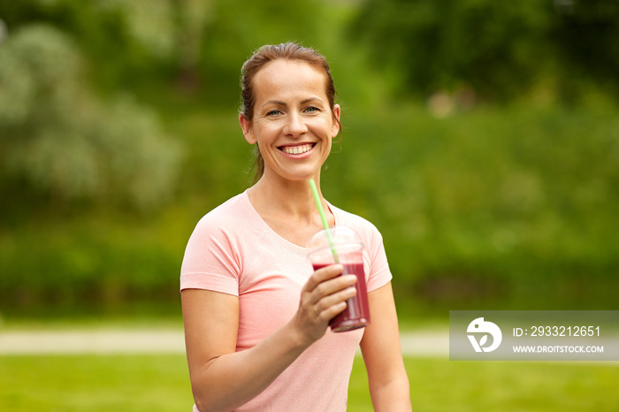 fitness, sport and healthy lifestyle concept - woman drinking takeaway smoothie or shake from plasti