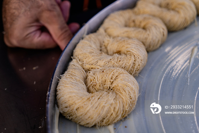 Putting rolled Kadayıf dough to tray