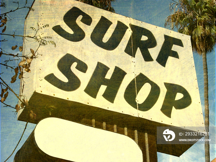 aged and worn surf shop sign with palm trees