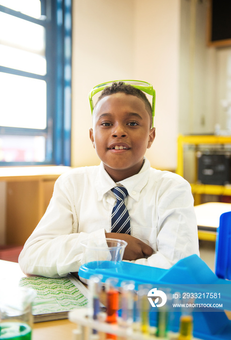 School boy (8-9) in science class