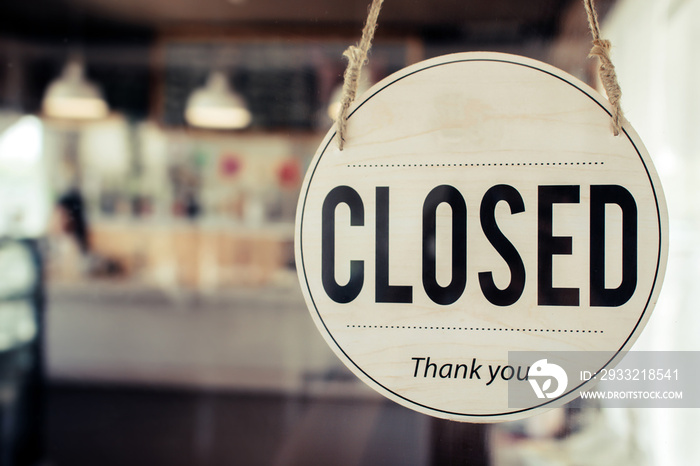 Closed. coffee cafe shop text on vintage sign board hanging on glass door in modern cafe shop reopen