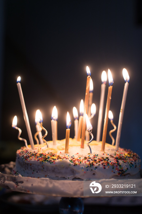 Lit candles on homemade birthday cake