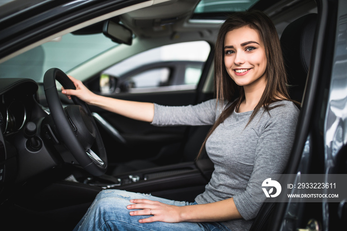 attractive woman at car drivers seat