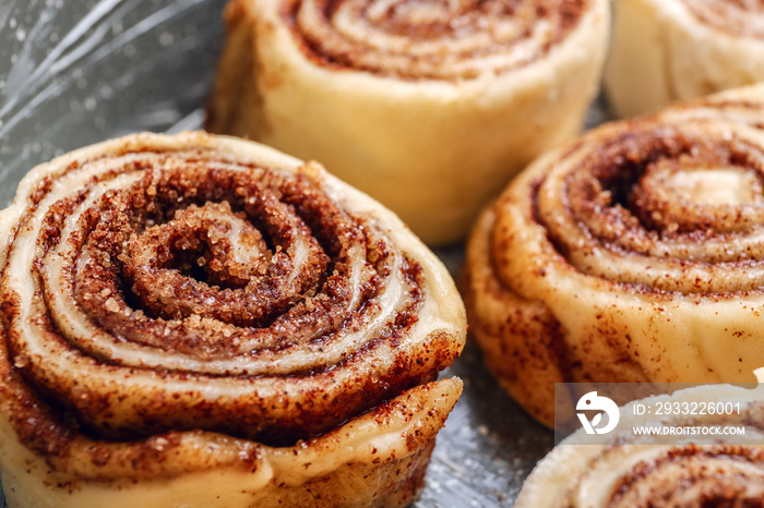 Uncooked cinnamon rolls in baking dish, closeup