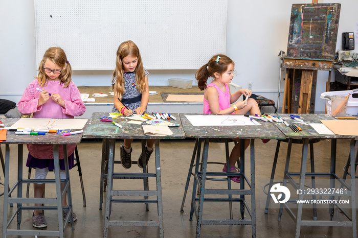 Young girls drawing in a classroom