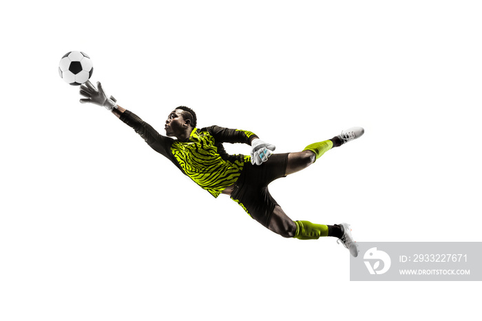 Male soccer player goalkeeper catching ball in jump. Silhouette of fit man with ball isolated on whi