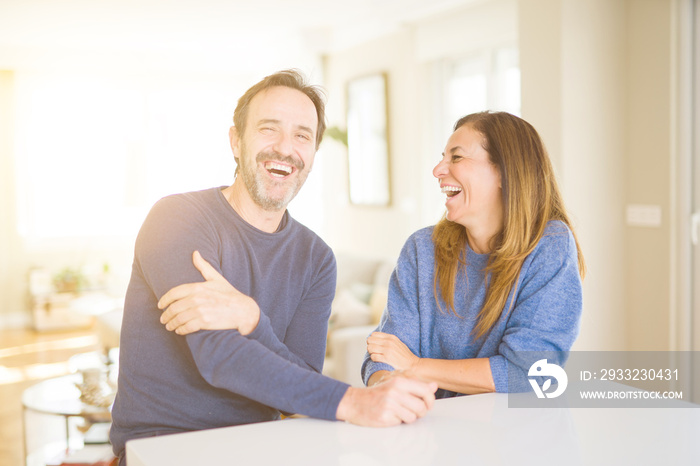 Romantic middle age couple sitting together at home