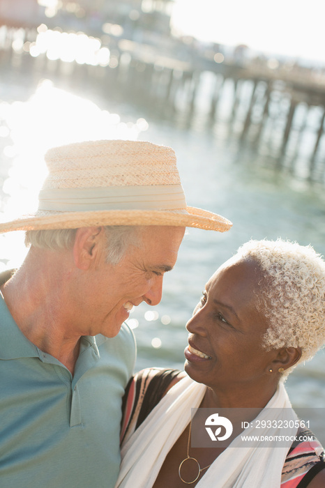 Happy senior couple on sunny ocean pier