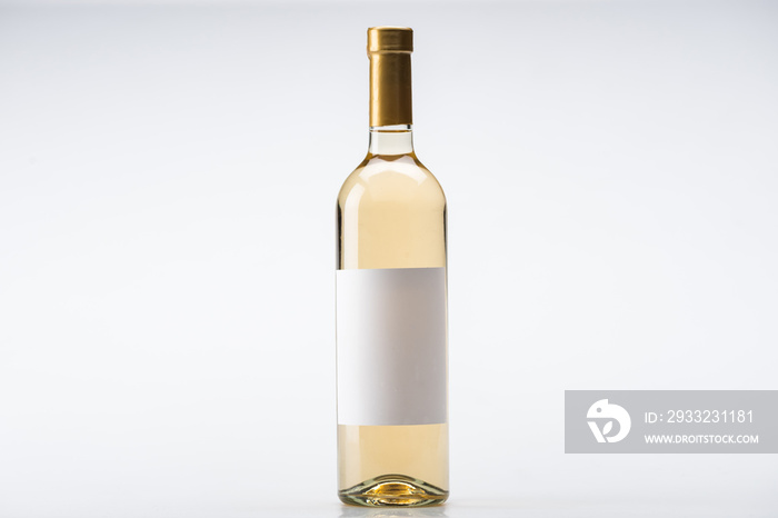 bottle of white wine with blank label on white background