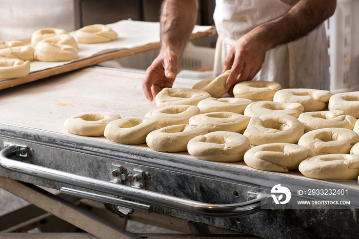 Baker hands making bread donuts