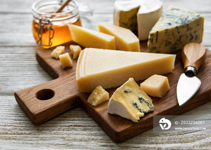 Various types of cheese  on a white wooden  background