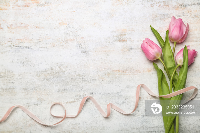 Composition with ribbon and flowers for International Womens Day celebration on light background