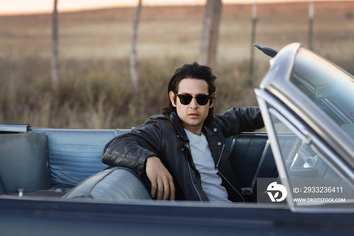 Portrait of young man in convertible