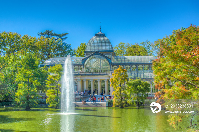 Fountain in a pond in front of the crystal palace at the Parque del Buen Retiro in Madrid, Spain