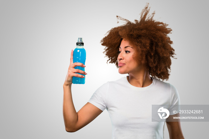 young fitness afro woman drinking an energy drink