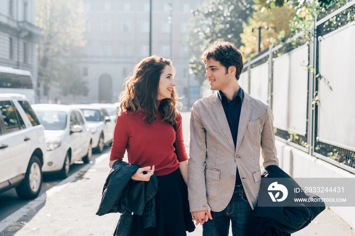 Young beautiful couple in love chatting walking outdoor in the city, having fun - first date,  roman