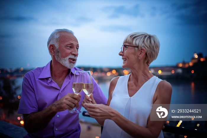 Senior couple celebrate outdoors.