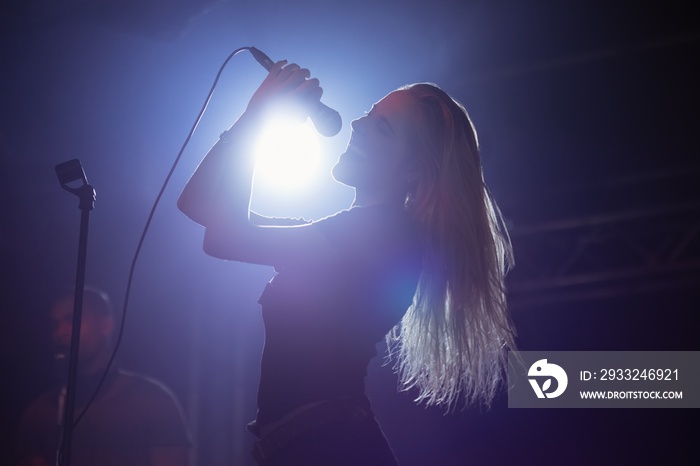 Cheerful female singer at nightclub