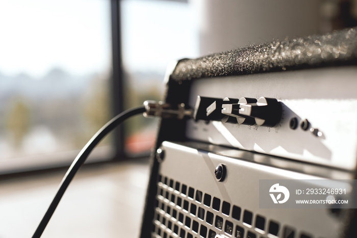 Powerful sound of your guitar. Close-up view of guitar amplifier with cable audio jack.