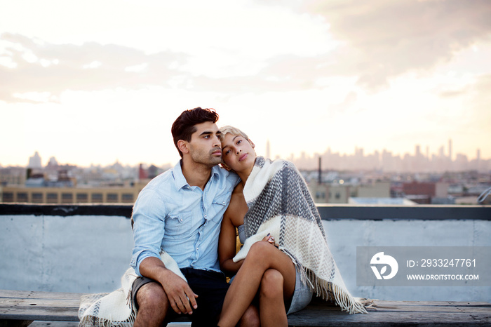Couple sitting on roof of building