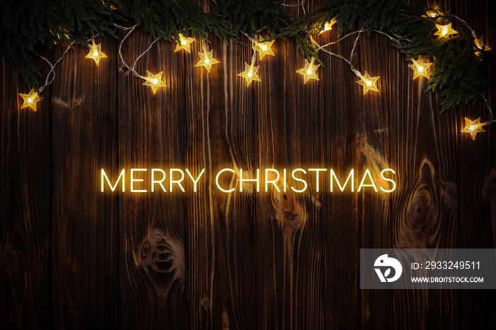 木制背景上的霓虹灯文字圣诞快乐。