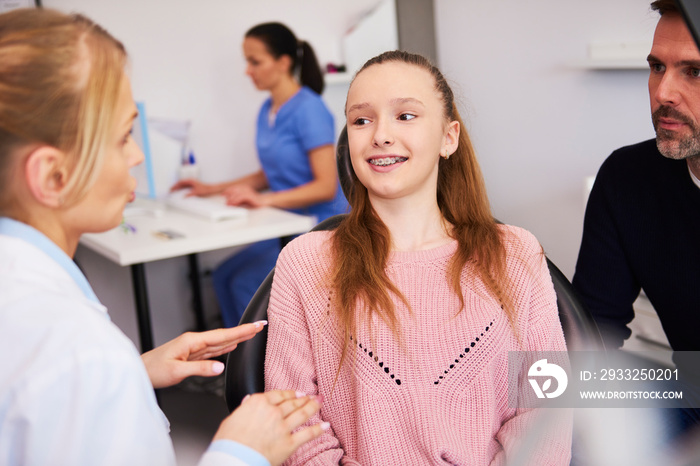 Female dentist and patient making a conversation