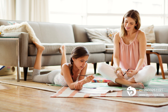 Girl (10-11) doing homework with her mom