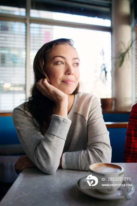 Young woman sitting at cafe