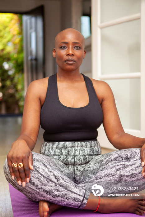 Mature woman meditating at home