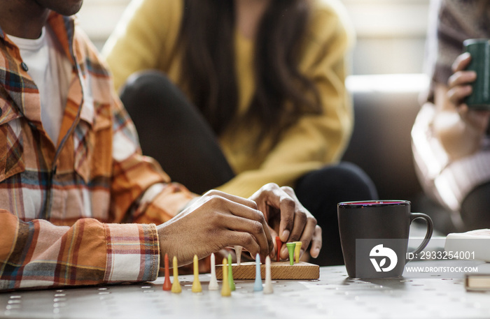 People playing board game in living room