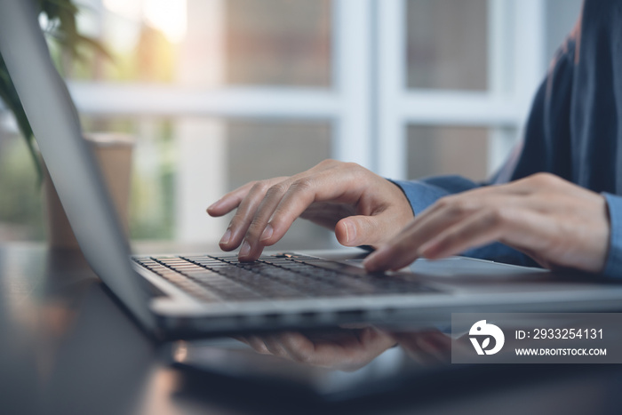 Business woman typing on laptop computer