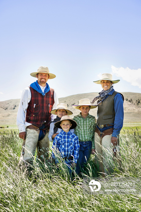 Portrait of family with three children (4-5,  8-9,  10-11) on ranch