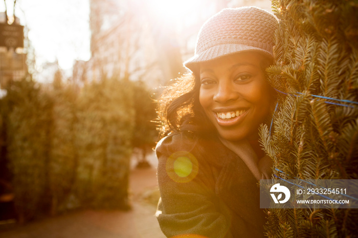 Laughing woman carrying Christmas tree