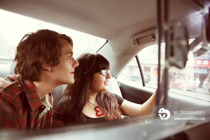 Young couple sitting in taxi