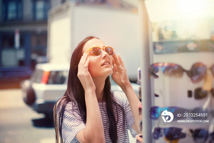 Woman trying on sunglasses