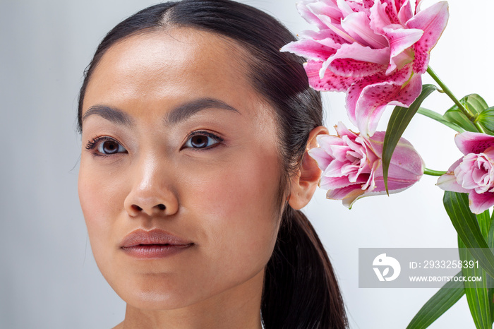 Close-up of woman and white and�purple lily flower