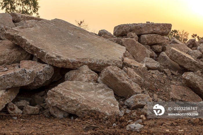 Concrete debris piles on the ground.