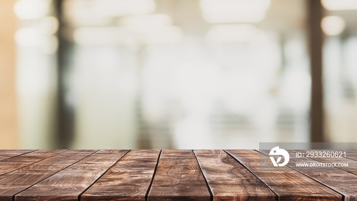 Empty wood table top and blurred restaurant interior background - can used for display or montage yo