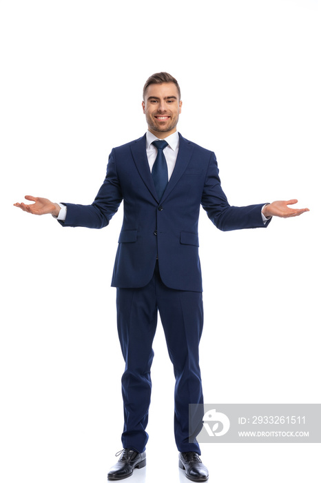 happy businessman in navy blue suit opening arms and smiling