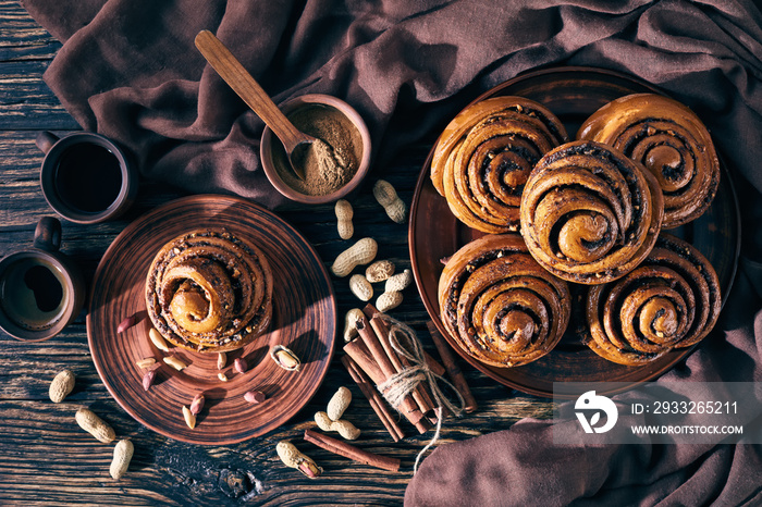 Cinnamon rolls buns with peanuts on a plate