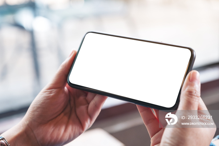 Mockup image of womans hands holding black mobile phone with blank desktop screen