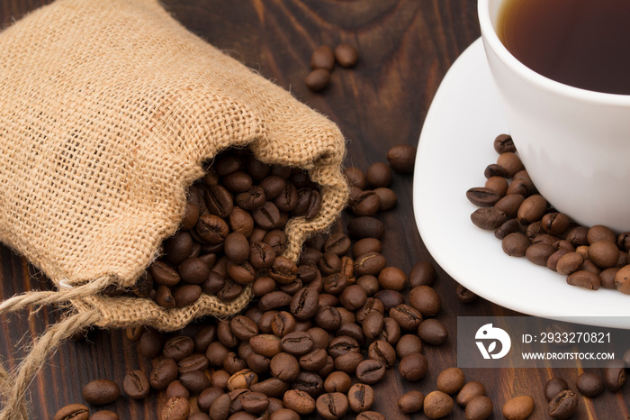 Coffee cup with coffee bag on wooden table. coffeee beans