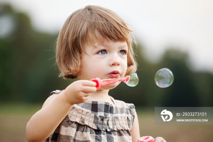 Close up of girl blowing bubbles in Prospect Park