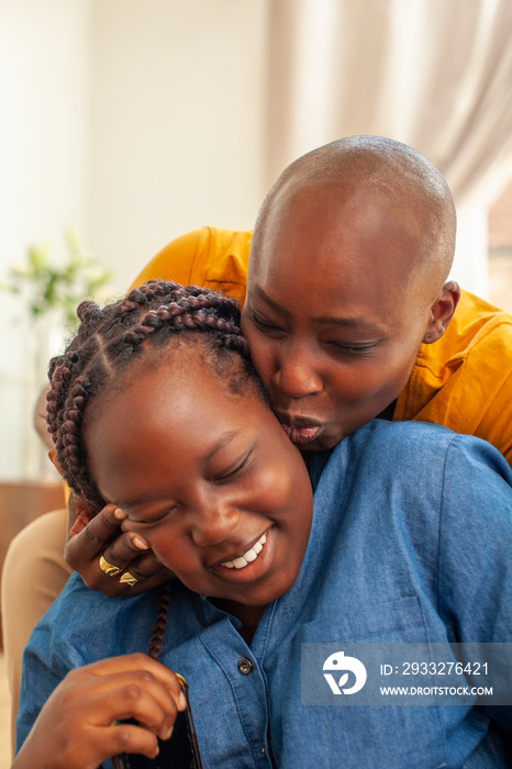 Mother kissing daughter on cheek