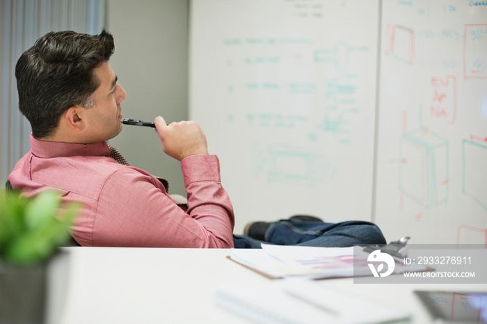 Businessman planning business strategy while sitting in board room