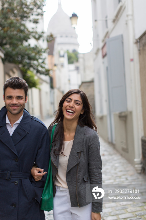 Portrait happy couple walking in Montmartre, Paris, France